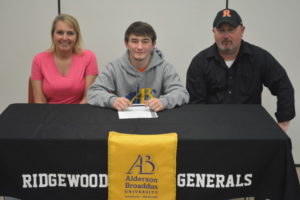 Colton Bethel, center, signed his letter of intent to wrestle at Alderson Broaddus University. The Ridgewood High School senior is pictured here with his stepmother Kelly Bethel and father Tim Bethel. Josie Sellers | Beacon