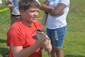 Coshocton Elementary School sixth grader Michael Mills showed a cat fish to his classmates during the AEP Conesville Plant Earth Day celebration on May 17. Josie Sellers | Beacon