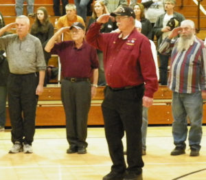 Retired and active military salute the flag during the National Anthem at River View High School as part of a ceremony honoring all active and retired military personnel. Jen Jones | Beacon