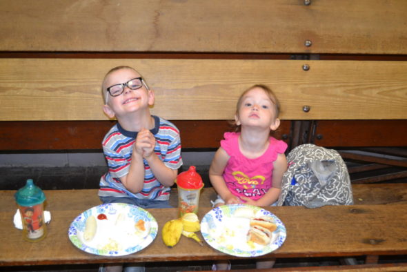 Caden and Kensie Renner enjoy their hot dogs, bananas and popcorn at the Hopewell Industries carnival at the Salvation Army on July 13. Both children won several prizes, including their favorites - candy and a slinky. Jen Jones | Beacon