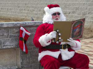 Santa Claus reads "Twas the Night Before Christmas" to the crowd at the first Our Town Coshocton Christmas event held Dec. 10. Jen Jones | Beacon