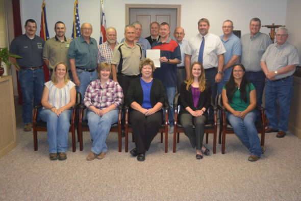 Pictured are past and present employees and district supervisors who have been involved with the Coshocton Soil and Water Conservation District over the years. Holding the proclamation celebrating the organization’s 75th anniversary is Greg Waters, chairman of the board of supervisors. At his left is Commissioner Gary Fischer and at his right is Commissioner Curtis Lee. The commissioners honored the Coshocton Soil and Water Conservation District with a special proclamation to commemorate their 75th anniversary at their regular meeting on May 24. Josie Sellers | Beacon