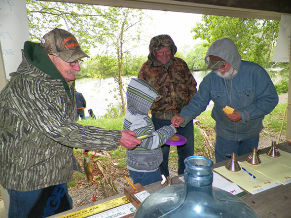 CCSA members Skip Lawrence, Kendall Woods and Ray Rogers offer small prizes to a young fisherman who had just had his catch measured at the CCSA Fishing Derby on May 6 at Lake Park. Jen Jones | Beacon
