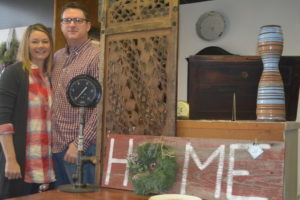 Jennifer and Greg Coffman pose for a picture near some of the items available for purchase at Jennifer’s Rust Decor. The home decor store will be open to the public the first weekend of the month and feature new items every time. Josie Sellers | Beacon